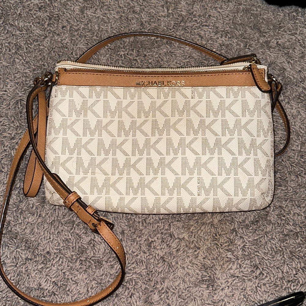 Michael kors satchel. Has a black discoloration from it rubbing on my leggings